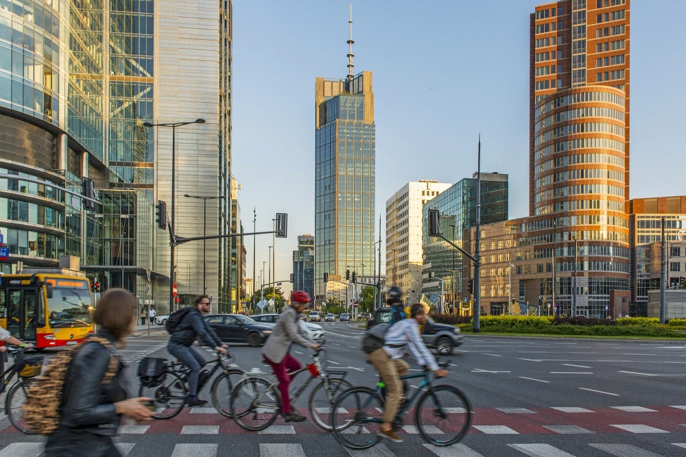 bikers passing Varso Tower in the background