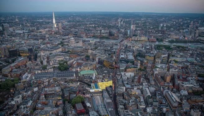 Aerial view of London at dusk, looking across Smithfield Market and St Paul's Cathedral to Bankside
